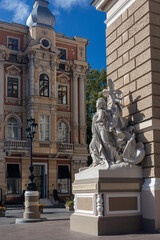 Obraz premium Classic European architecture with detailed stone statue in sunny urban Odesa city plaza