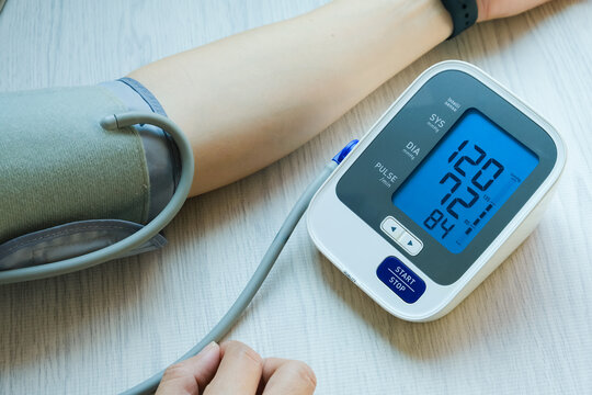 Man check blood pressure monitor and heart rate monitor with digital pressure gauge. Health care and Medical concept	