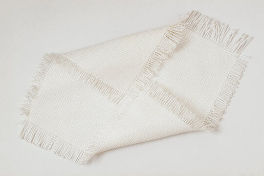 Fabric texture sample with woven threads and fringe edges placed on surface, textile sample, neutral modern tone, detailed weave pattern for design. Natural background, fabric texture
