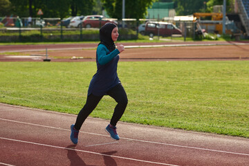 Fototapeta premium Muslim Woman Running on Outdoor Track in Hijab Training for Fitness and Athletic Wellness