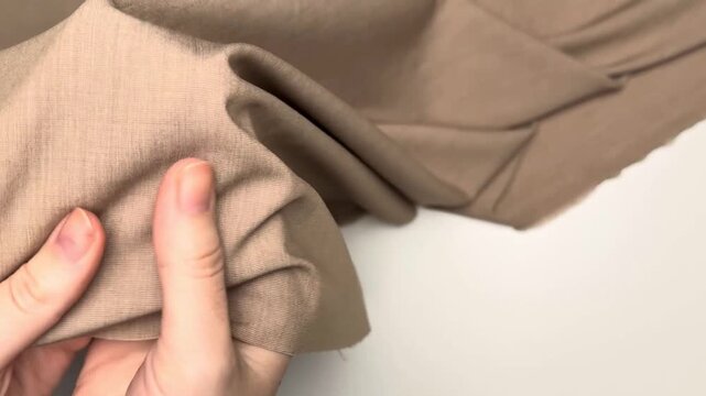 Beige melange stretch fabric presenting a soft texture and subtle elasticity suitable for creating stylish suits and comfortable apparel with excellent drape and breathability.