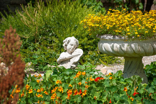 Cherub Statue in a Blooming Garden