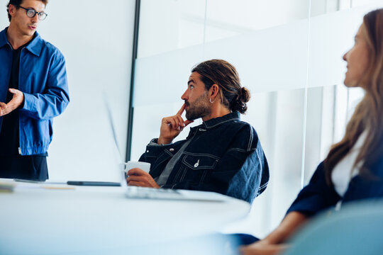 Professionals engaged in focused discussion during office meeting