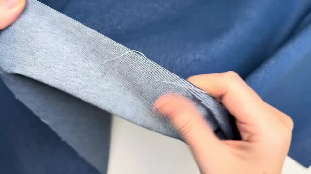 Thick blue cotton blend twill material with visible diagonal texture suitable for durable garments and structured sewing applications requiring sturdy fabric.