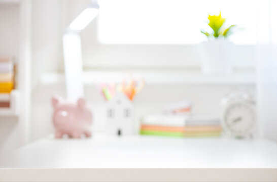 Blurred educational background with classroom white table interior and place for your design in front