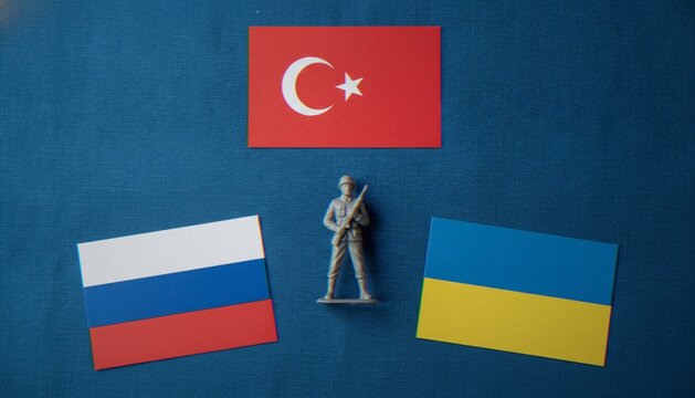 A plastic toy soldier positioned between the flags of Turkey, Russia, and Ukraine on a blue background, representing geopolitical conflict and international diplomacy.