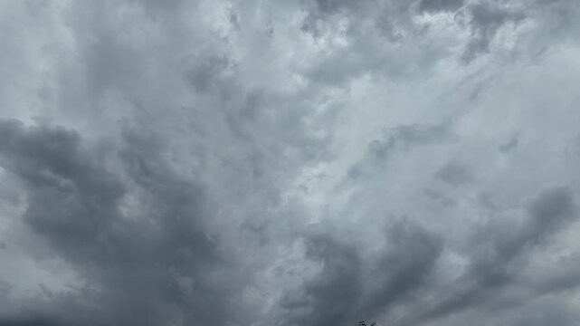 Black and gray clouds cover the sky. Clouds are approaching before a storm and rain with a thunderstorm