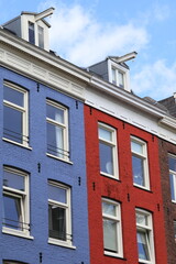 Obraz premium Blue and Red House Facades with Dormers in Amsterdam, De Pijp Neighbourhood, Netherlands