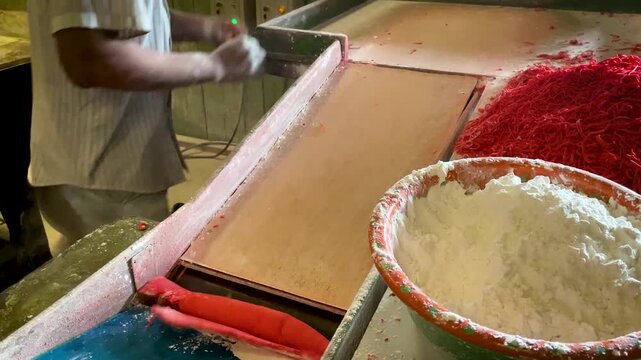 Worker Hands Preparing Red Noodle Dough With Flour in Traditional Mie Habang Production Workshop Indonesia