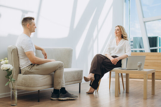 Psychologist discussing mental health with man in session