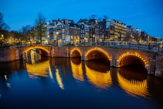 Canal Herengracht in Amsterdam, Netherlands, at night in Blue Hour with reflections of lights on water