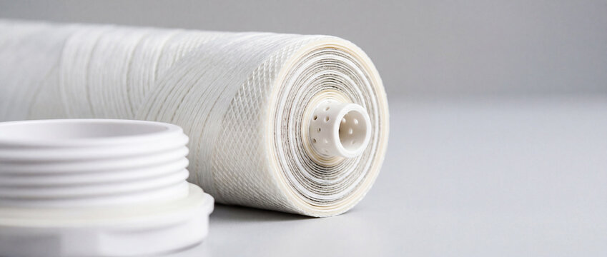 White water filter cartridge roll and cap close-up on neutral background for purification systems