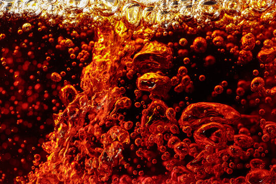 Carbonated drink is poured into a glass.