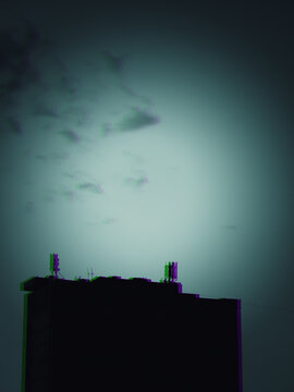 Urban building under heavy skies with RGB shift glitch effect