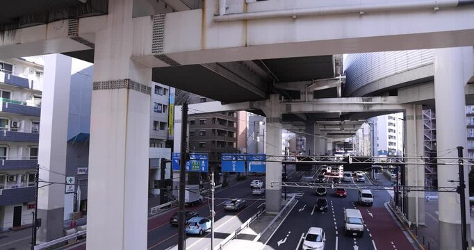 A cityscape of traffic jam at the city street under the overpass in Tokyo wide shot