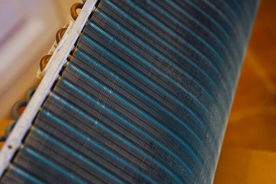Close-up of industrial radiator fins for cooling and heat exchange technology.