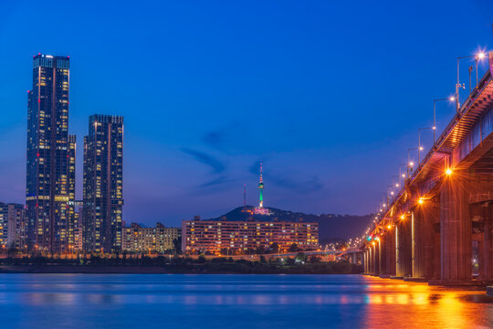 Stunning twilight night view of the illuminated Dongjak Bridge spanning across Han River with N Seoul Tower on Namsan mountain in the background, Seoul, South Korea.