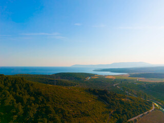 Naklejka premium Aerial view of coastal mountains, valley, and blue aegean sea