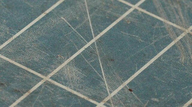 4K video of a blue tiled surface featuring visible linear patterns and geometric lines. The close-up view highlights texture, color, structure, and decorative details. Ideal for backgrounds