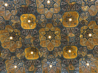 Karbala, Iraq - December 25, 2025: Exterior architectural view of the Holy Shrine of Imam Hussain, showcasing ornate Islamic tilework, arched windows, Arabic calligraphy and architecture  © hasan