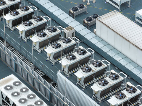 Aerial view of industrial HVAC cooling units and ventilation systems on the rooftop of the Datacenter T-Mobile in Warsaw, Wojewodztwo mazowieckie, Poland.