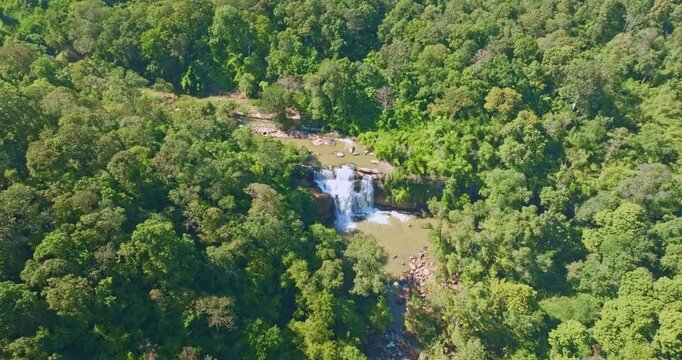 Scenic aerial panorama of Tat Huang Waterfall inside Phu Suan Sai National Park. The Huangs River cascades through vibrant jungle greenery, offering a tranquil and authentic Southeast Asian nature