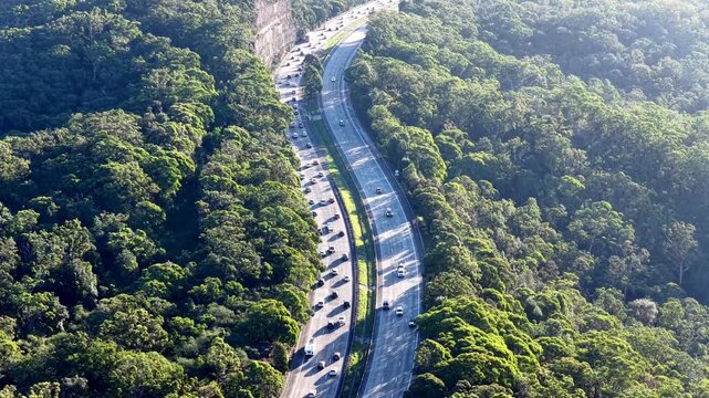 Creek bridge on Motorway One to Sydney heavy holiday traffic aerial view above lanes.