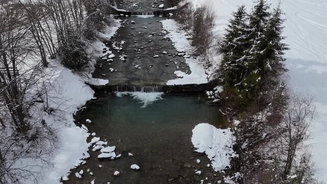 Top-Down Forward Drone Flight Over Snowy Stream in South Tyrol, Italian Alps
