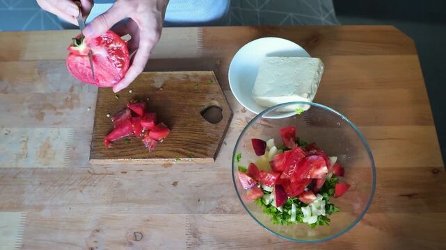 Preparing Fresh Vegetable Salad with Tomato Tofu and Greens in Home video Full HD Kitchen