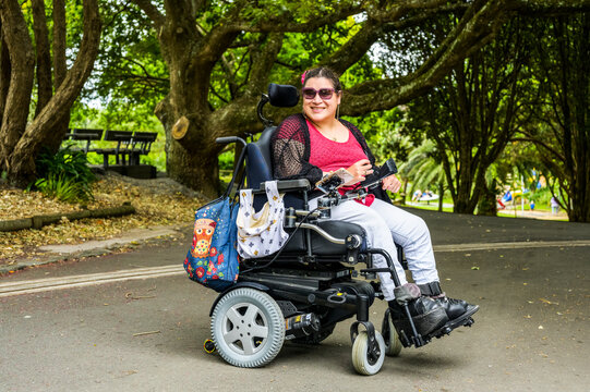 Maori woman with Cerebral Palsy in a wheelchair in a park area