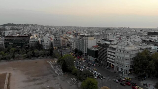 Aerial drone video of  Plaka district, Lycabettus Hill, Vasilissis Amalias Avenue in Athens, near Acropolis and Parthenon Acropolis hill, Plaka picturesque district below, Athens historic centre, Atti