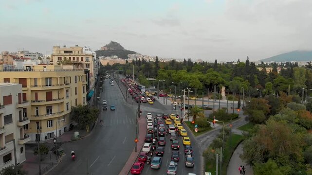 Aerial drone video of  Plaka district, Lycabettus Hill, Vasilissis Amalias Avenue in Athens, near Acropolis and Parthenon Acropolis hill, Plaka picturesque district below, Athens historic centre, Atti