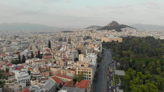 Aerial drone video of  Plaka district, Lycabettus Hill, Vasilissis Amalias Avenue in Athens, near Acropolis and Parthenon Acropolis hill, Plaka picturesque district below, Athens historic centre, Atti