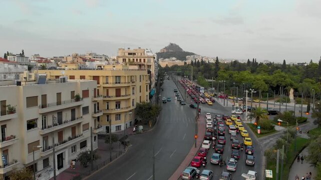 Aerial drone video of  Plaka district, Lycabettus Hill, Vasilissis Amalias Avenue in Athens, near Acropolis and Parthenon Acropolis hill, Plaka picturesque district below, Athens historic centre, Atti