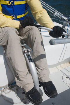 Disabled man steering boat, low section