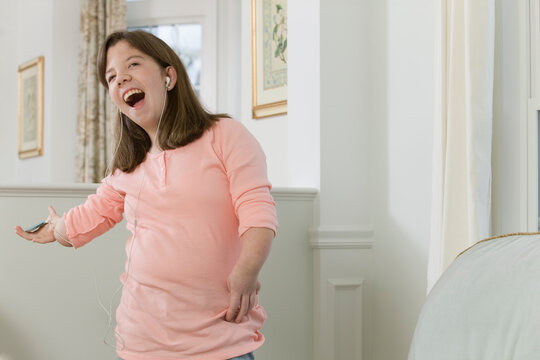 Teenage girl listening to an MP3 player in hand with birth defect
