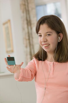 Teenage girl listening to an MP3 player in hand with birth defect