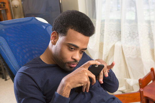Young man with disability holding a smart phone