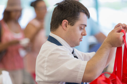 Man with Down Syndrome working at a grocery store