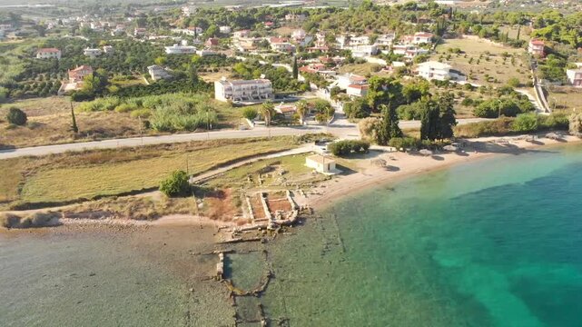 Aerial view of beach and sea, ruins remains of Ancient Port of Kenchreai, Kechries near Corinth Canal. Drone view from above. 
