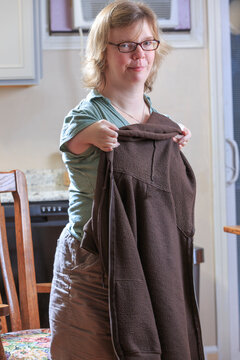 Woman with TAR Syndrome putting on her jacket