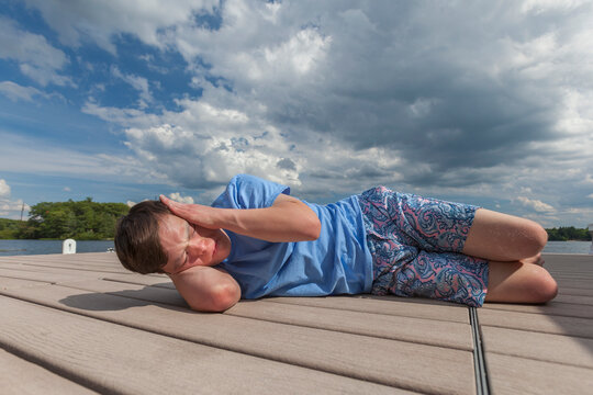 Young man with Down Syndrome playing on a dock