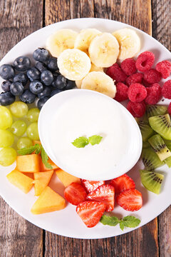 fruit platter with yogurt dip and assorted fresh berries and slices