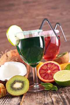 tropical cocktails with fresh kiwi lime and coconut on wooden table