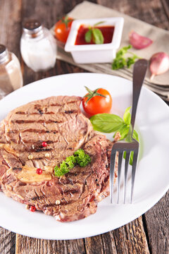 grilled beef steak with peppercorns and cherry tomato on plate