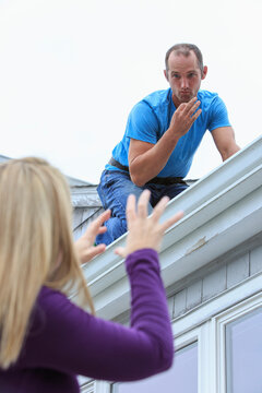 Homeowner and roofer communicating in American Sign Language about 'Rain' and 'Soon'