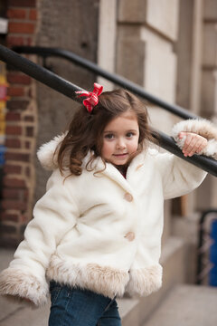 Portrait of a young girl in a white coat