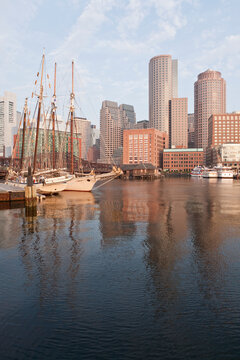 Boats with financial district on a harbor, Rowes Wharf