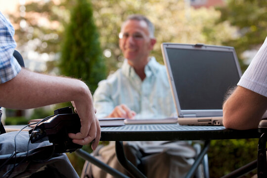 Three businessmen with disabilities at a cafa&Atilde;&permil;a