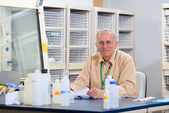 Engineering professor correcting papers in chemical laboratory